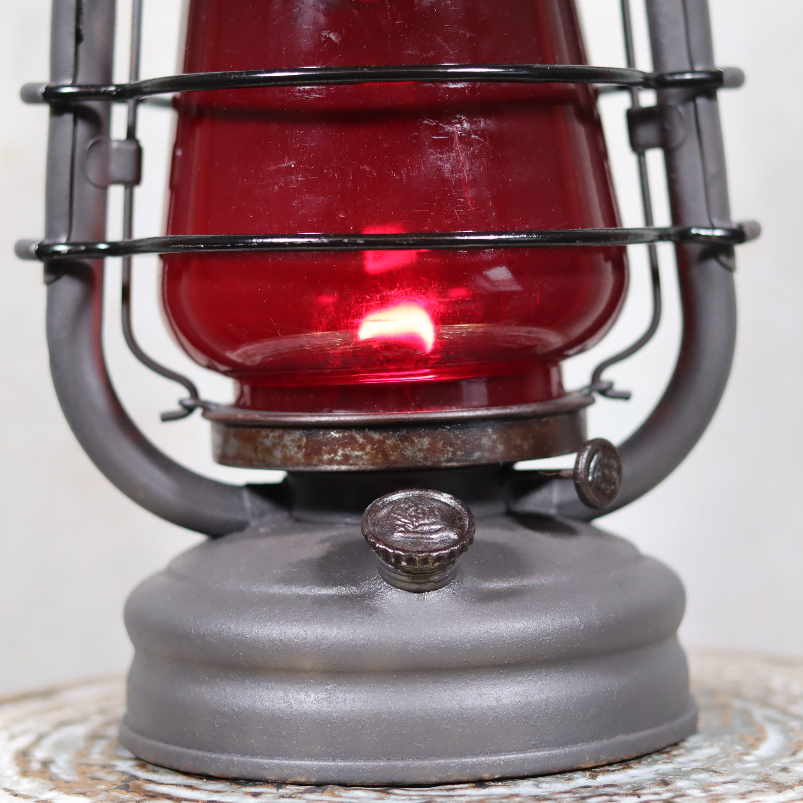Beautiful Feuerhand 201 Storm Lantern – Germany, 1930s – With Rare Red Logo Glass oil lamp lit inside metal frame