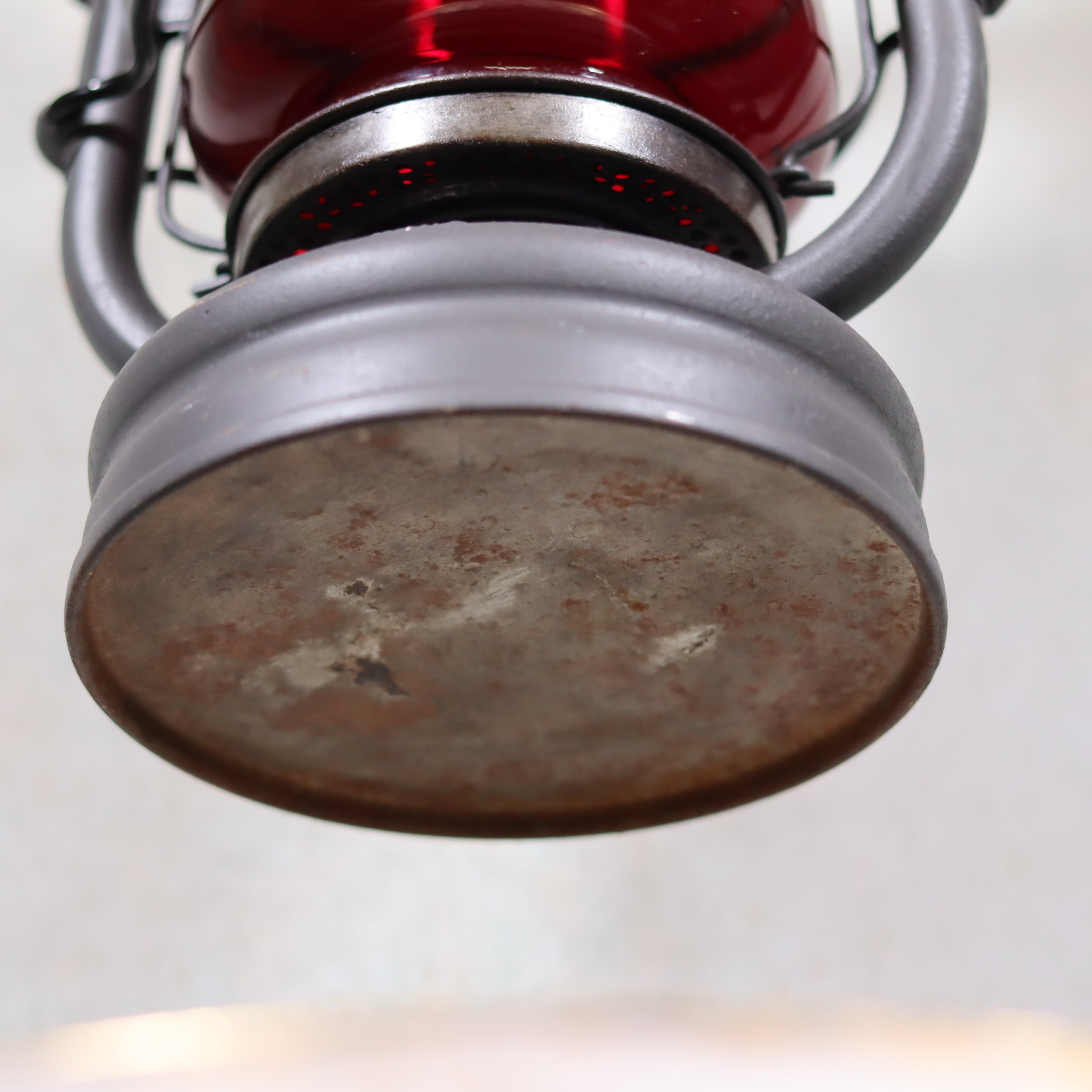 Beautiful Feuerhand 201 Storm Lantern – Germany, 1930s – With Rare Red Logo Glass showing the oil lamp base and metal frame close-up