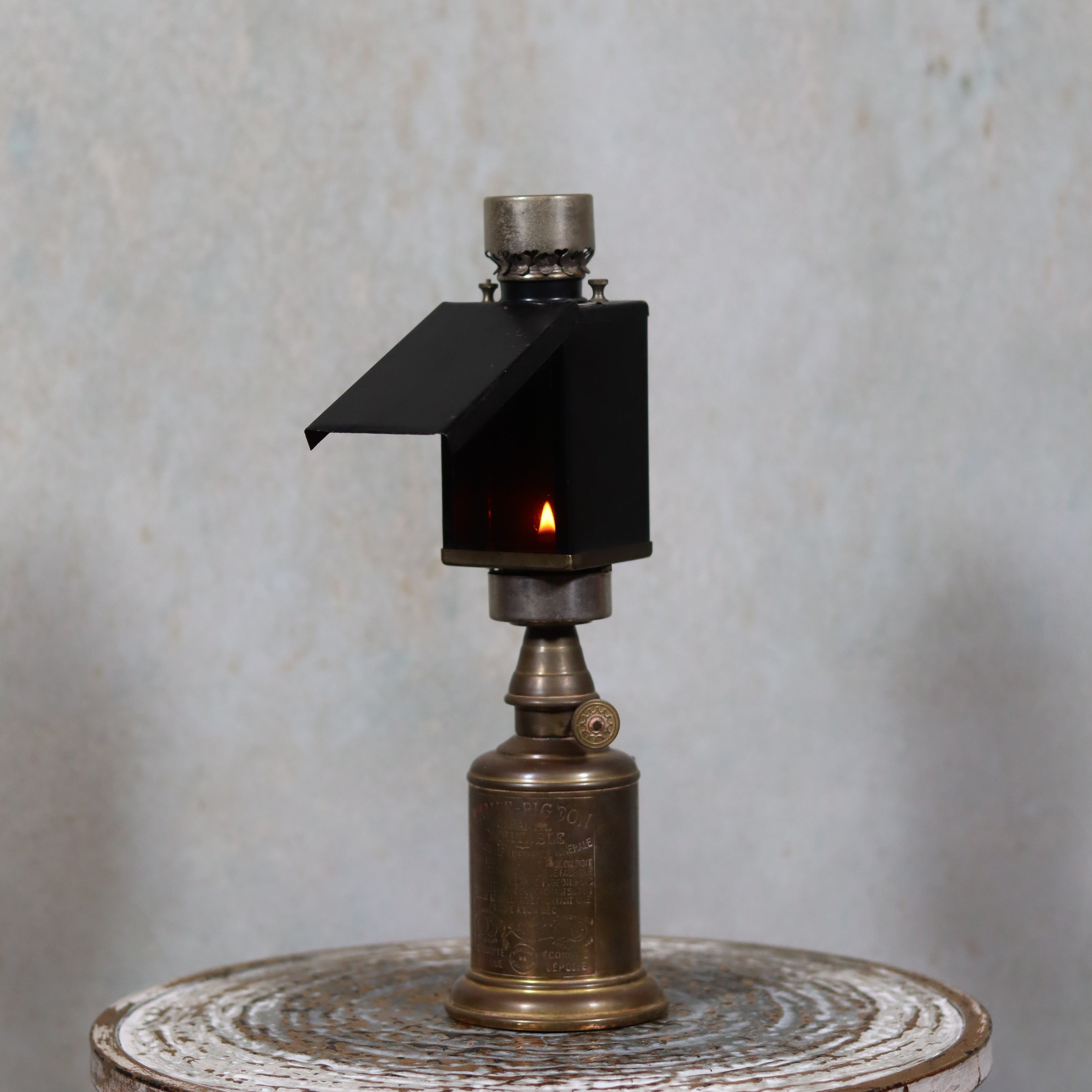 Rare Darkroom Oil Lamp – Pigeon Lamp with “Lampe Junius” Attachment – Excellent Condition showing vintage brass oil lamp with protective shade lit flame