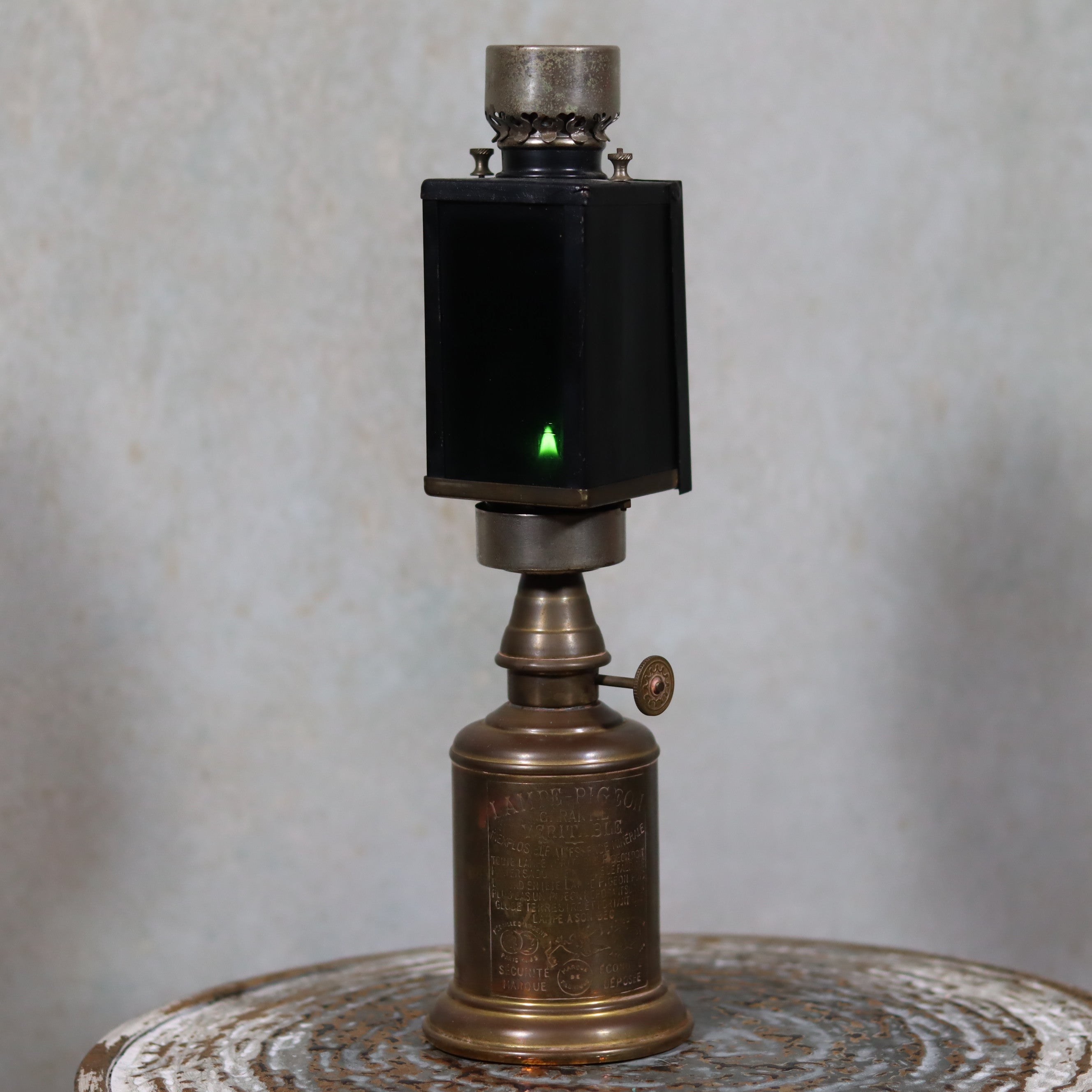 Rare Darkroom Oil Lamp – Pigeon Lamp with “Lampe Junius” Attachment – Excellent Condition shown lit on metallic surface