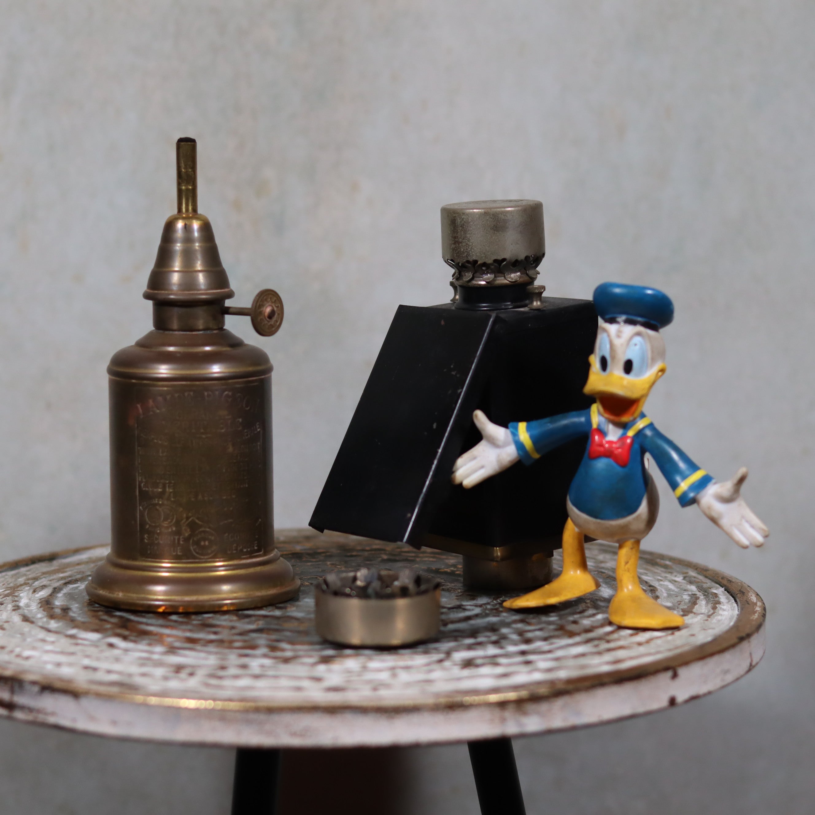 Rare Darkroom Oil Lamp – Pigeon Lamp with “Lampe Junius” Attachment – Excellent Condition displayed on round table with Donald Duck figure
