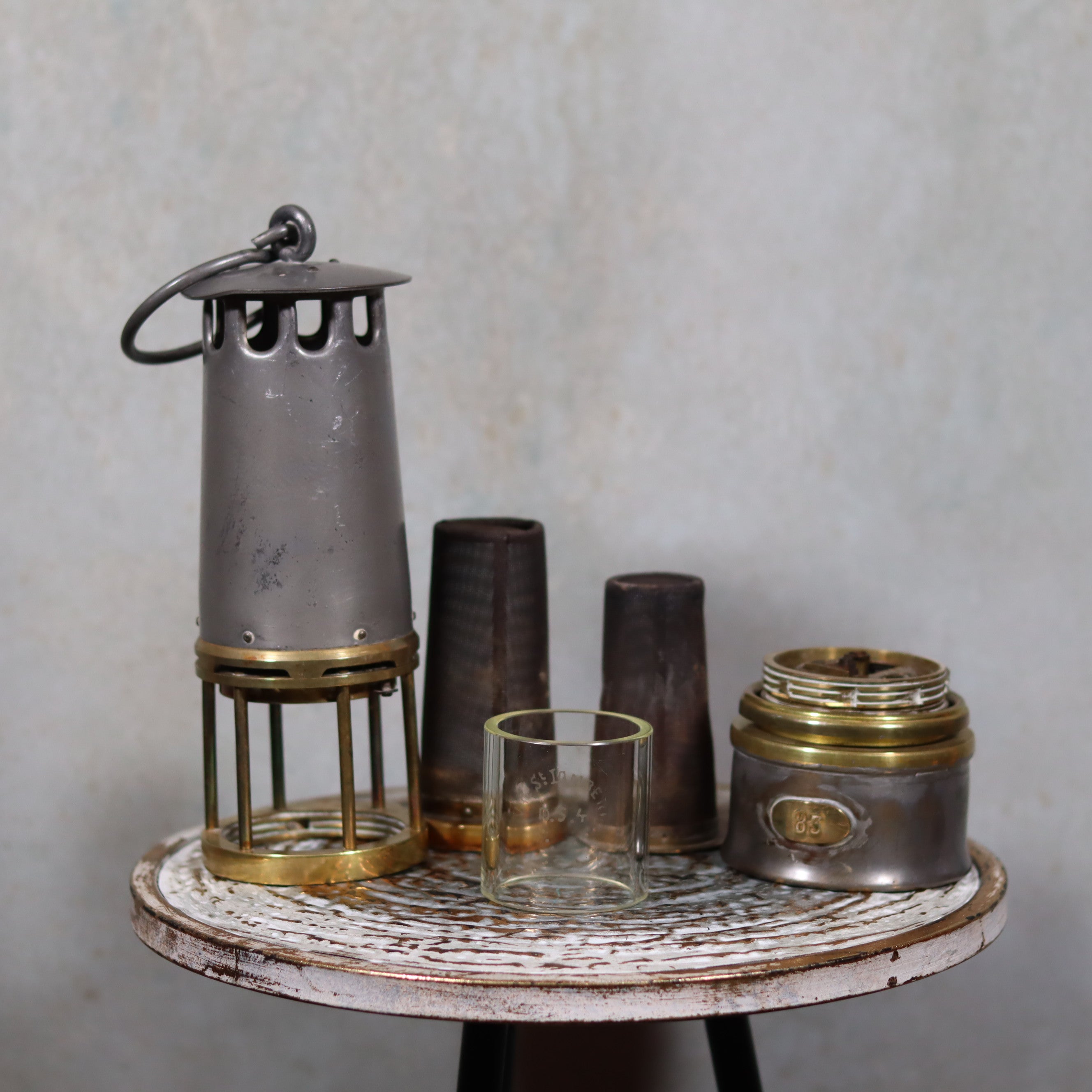 Beautiful, Almost Unused Miner’s Lamp by Hubert Joris (ca. 1900) with Val St. Lambert Glass displayed disassembled on white table.