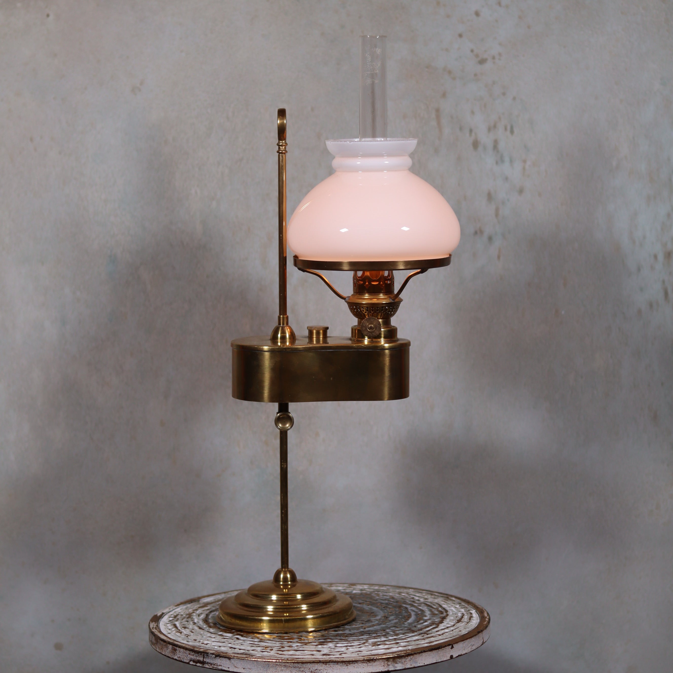 Rare and Elegant Brass Oil Lamp with Rising Glass and White Opal Shade – Adjustable Height – 1930s on rustic table