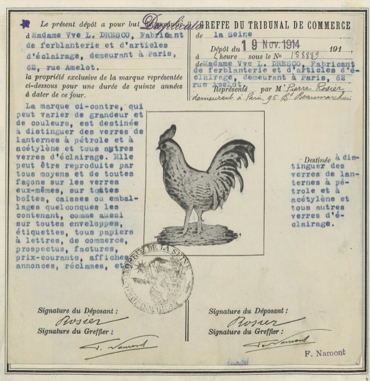 Antique oil lamps with detailed French trademark certificate featuring a rooster emblem and handwritten notes.