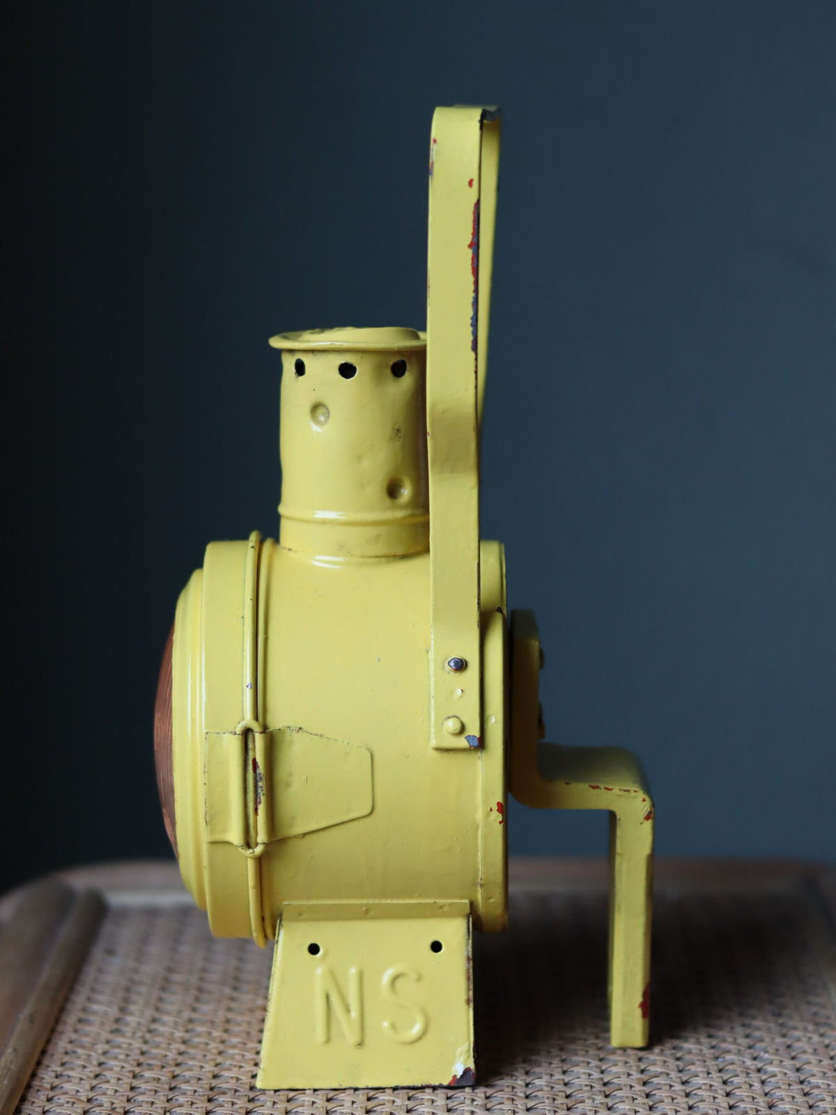 Vintage Dutch Railway Signal Lamp – NS Oil Lantern, 1930s in classic yellow with visible NS branding and detailed craftsmanship.