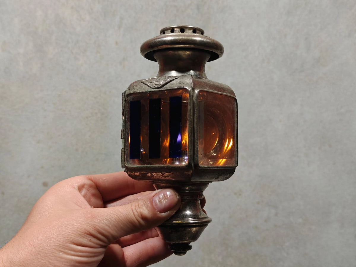 Extremely Rare Vintage Automobile Oil Lamp – Coll. J. Girard, Paris (1920s–1930s) held by hand showing lit flame inside metal frame