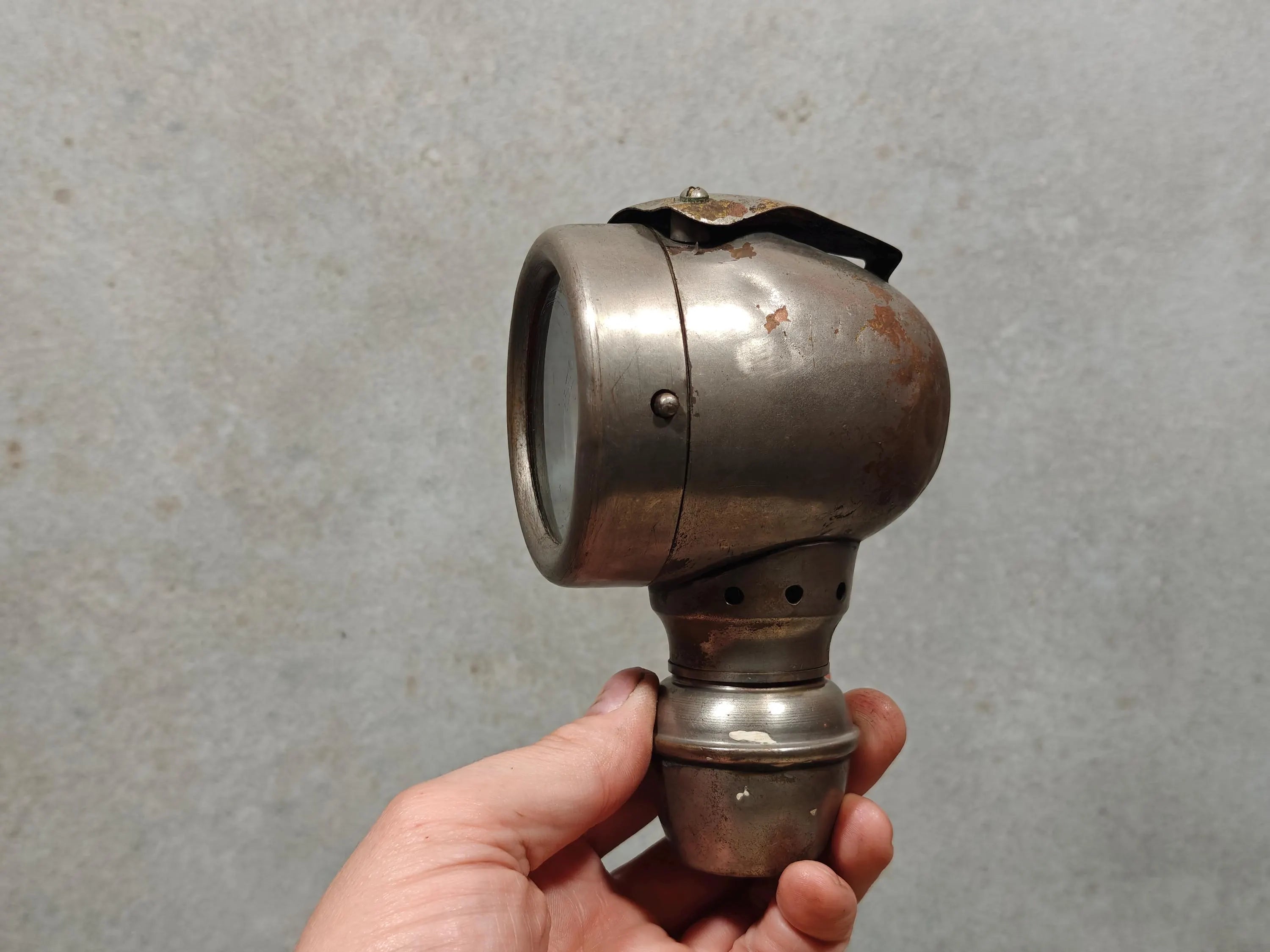 Rare Vintage Automobile Oil Lamp – French Side Lamp (1920s/30s) held showing its metal body and glass lens detail.