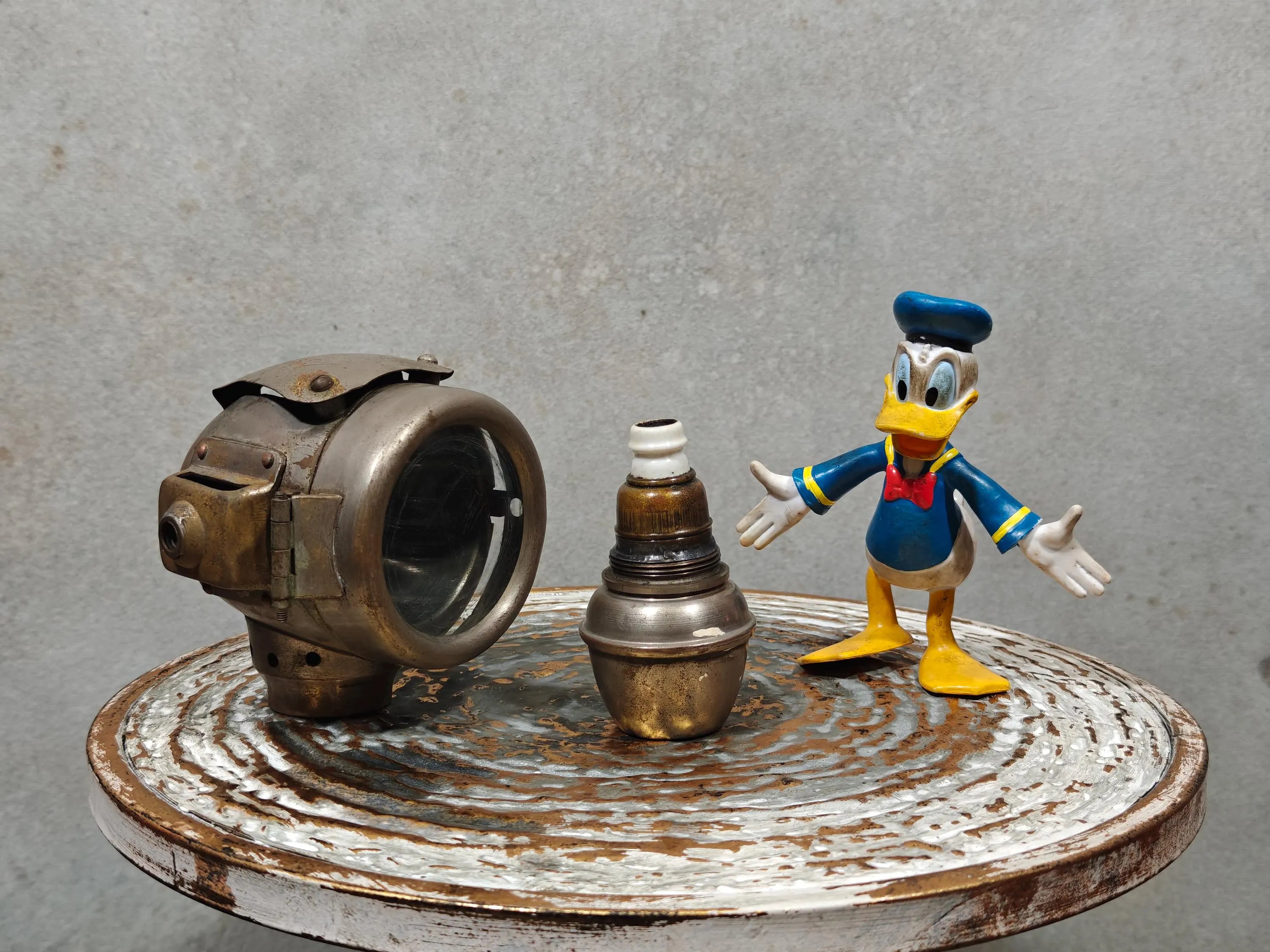 Rare Vintage Automobile Oil Lamp – French Side Lamp (1920s/30s) displayed with vintage parts and figure on rustic table