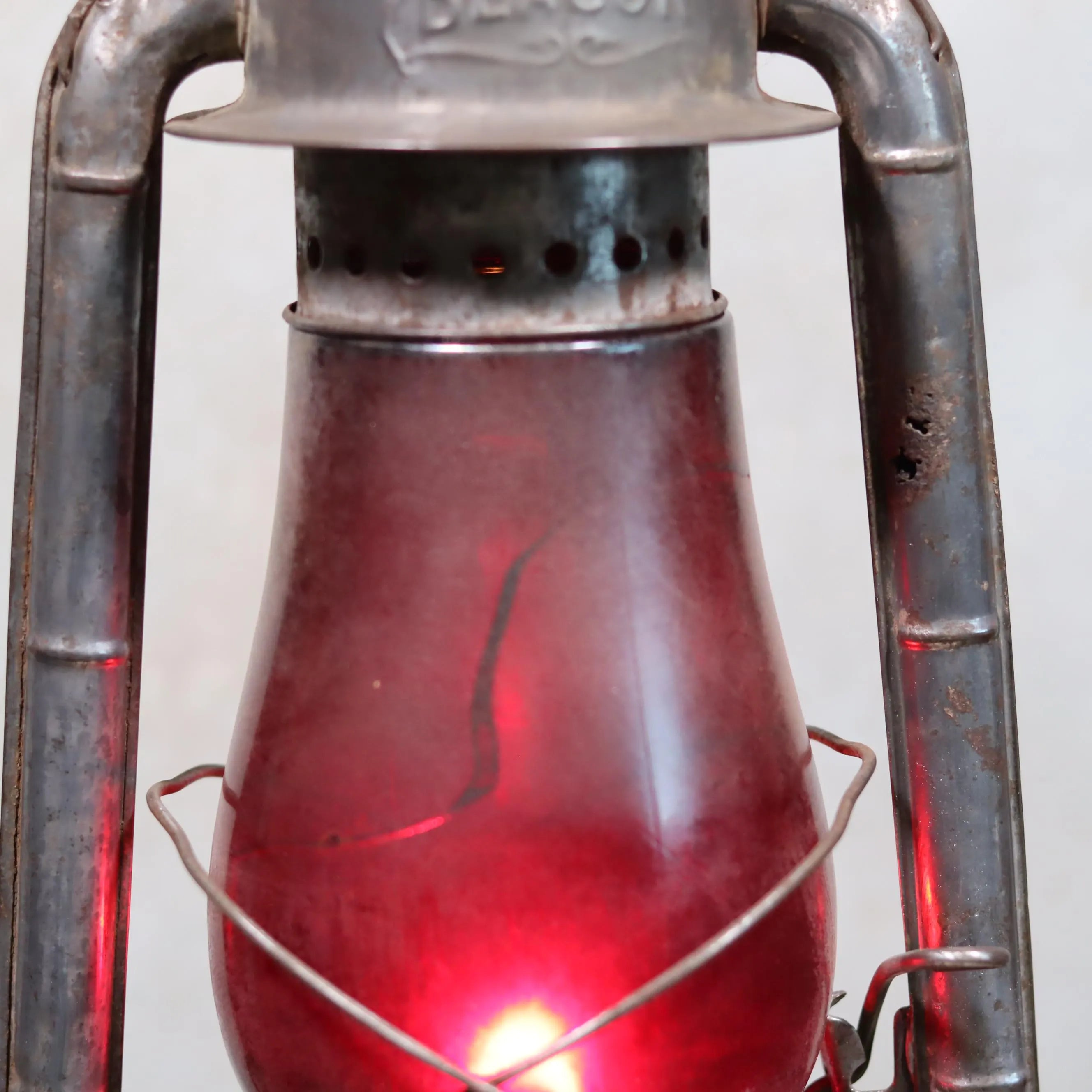 Rare Canadian Beacon Hurricane Lantern – Vintage Red Glass Kerosene Lamp with aged metal frame and glowing red globe