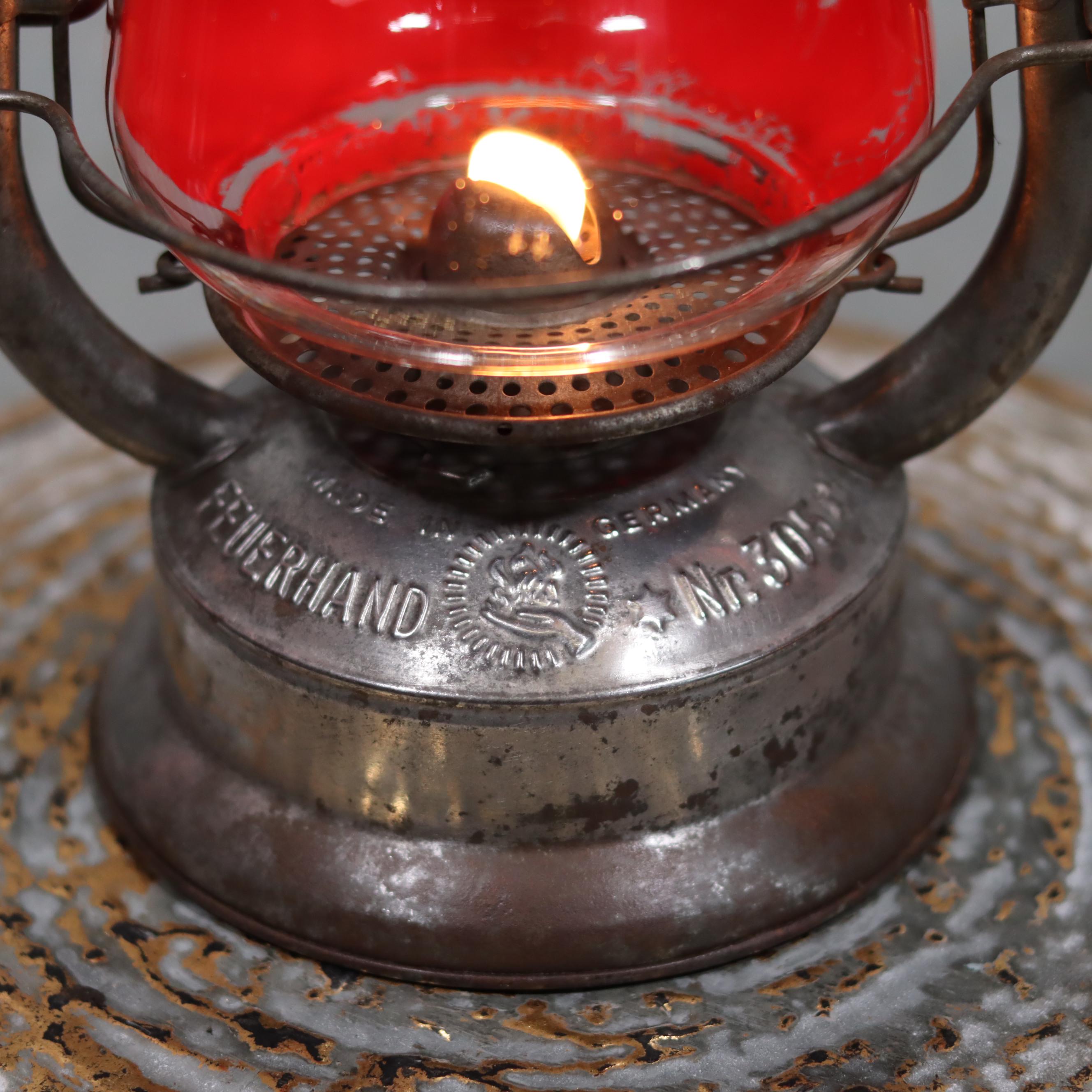 Rare Feuerhand 305 Hurricane Lantern – German Vintage Model (1930–1941) close-up of lit oil lamp wick and metal base