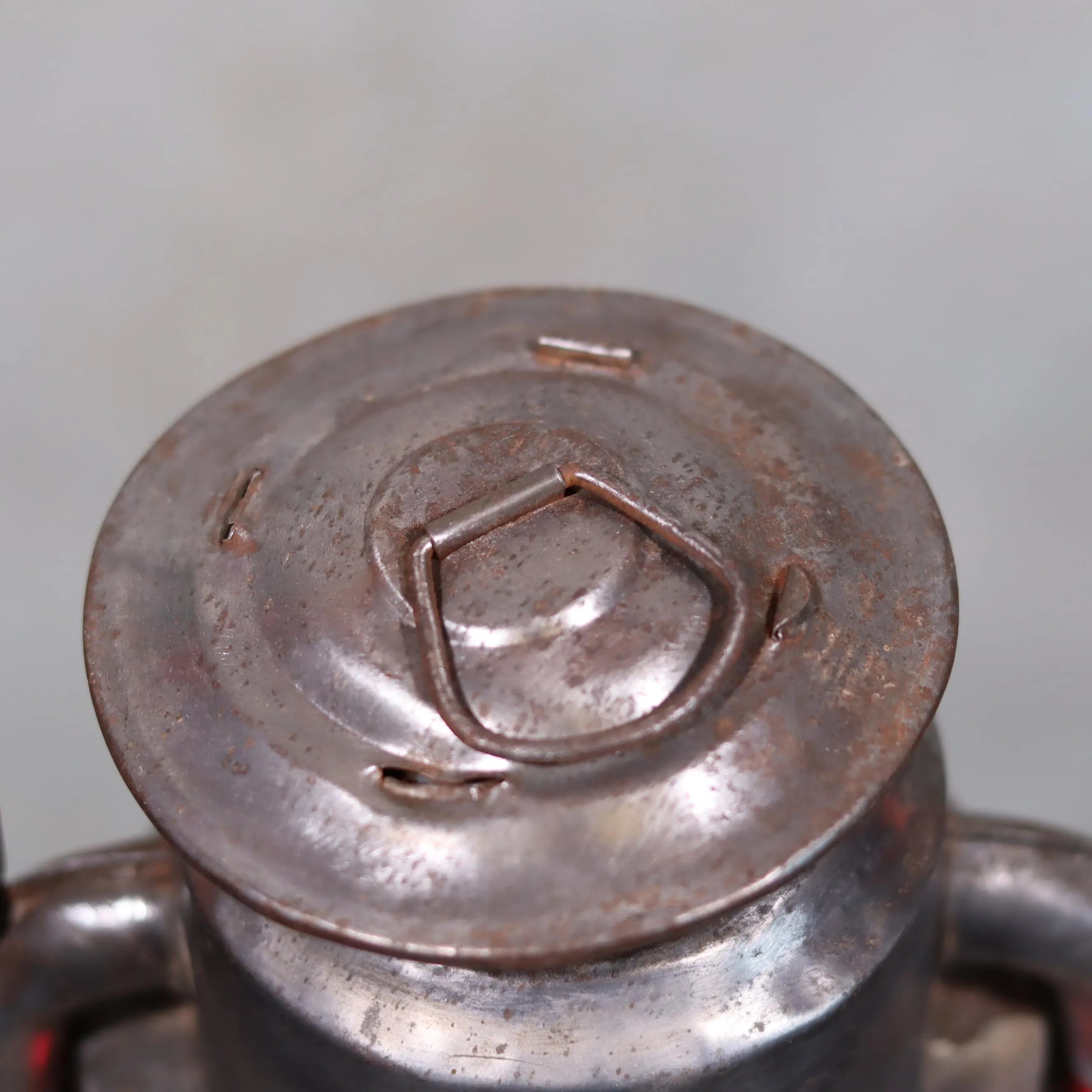Close-up of the metal top of Rare Canadian Beacon Hurricane Lantern – Vintage Red Glass Kerosene Lamp showing aged patina.