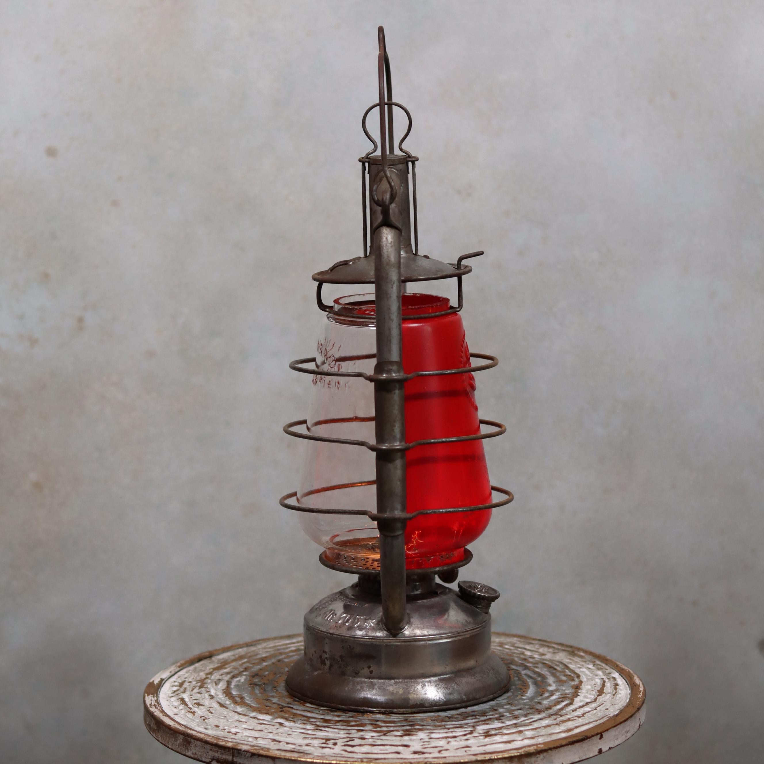 Rare Feuerhand 305 Hurricane Lantern – German Vintage Model (1930–1941) oil lamp with protective metal frame and red glass chimney.