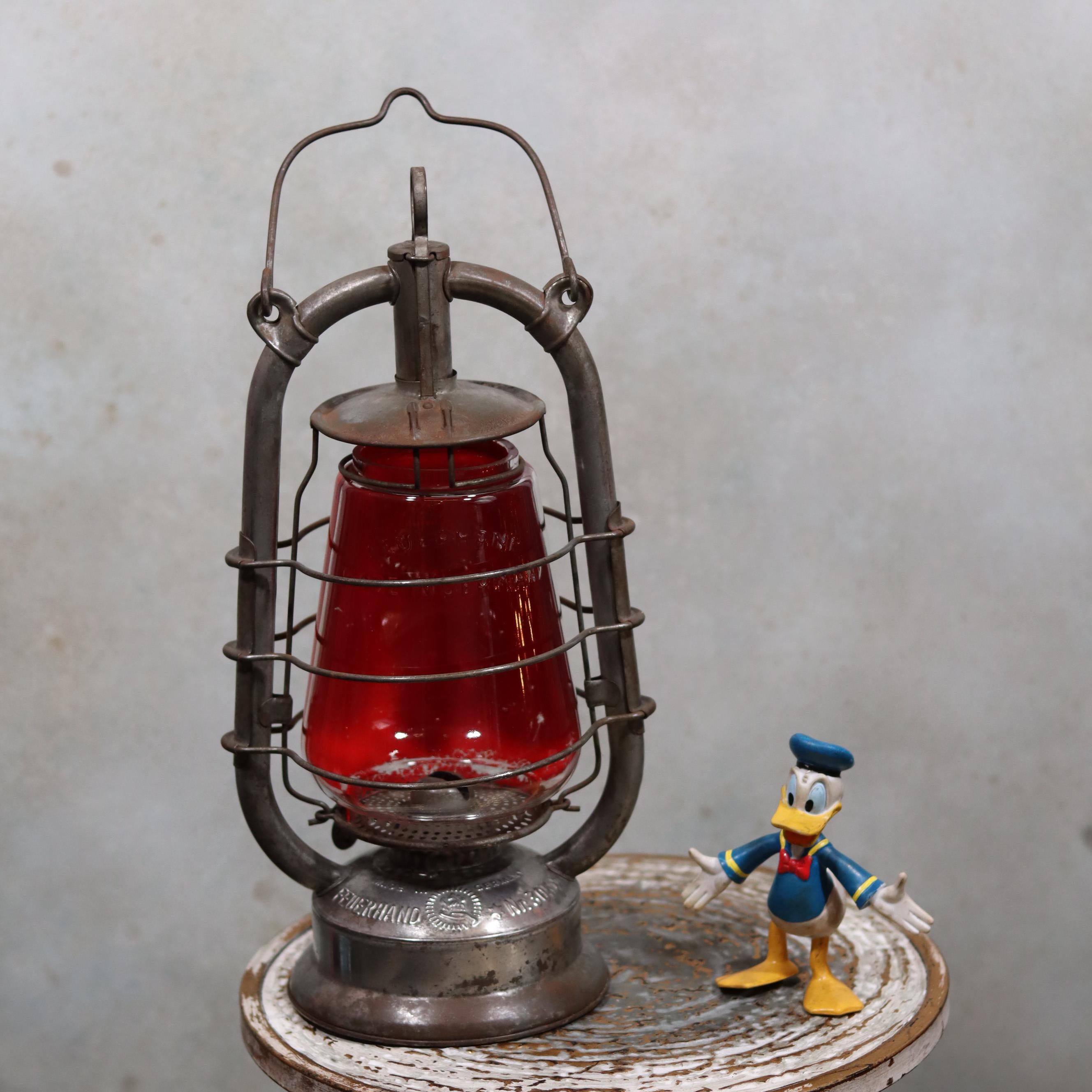 Rare Feuerhand 305 Hurricane Lantern – German Vintage Model (1930–1941) oil lamp with red glass and metal frame vintage design.